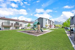 Ogden apartment for rent - a park with a playground in the middle of some apartments