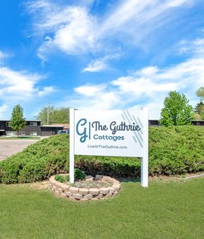 Roy apartment for rent - a sign for the gourmet coffees company in front of a grassy field