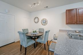 Saratoga Springs apartment for rent - a dining room with a table and chairs and a kitchen with a sink at Aldara Apartments in Saratoga Springs, Utah