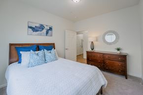 Saratoga Springs apartment for rent - a bedroom with a large bed and a dresser at Aldara Apartments in Saratoga Springs, Utah