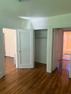 Salt Lake City apartment for rent - A room with a white door and wooden floors.