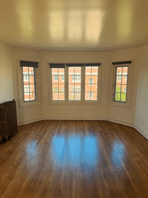 Salt Lake City apartment for rent - A room with wooden floors and three windows.