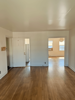 Salt Lake City apartment for rent - A room with wooden floors and white walls.