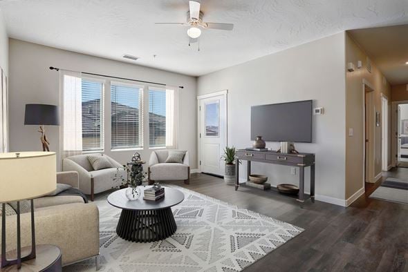 St. George apartment for rent - A living room with a large window, a flat screen TV, and a rug on the floor.