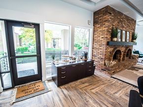 Orem apartment for rent - A modern interior with a brick fireplace and a kitchen island.