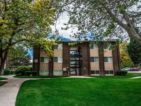 Orem apartment for rent - A building with a green lawn in front of it.