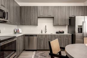 St. George townhouse for rent - A modern kitchen with a wooden chair and stainless steel appliances.