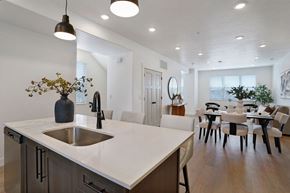 Riverdale townhouse for rent - A modern kitchen with a white countertop and a sink.