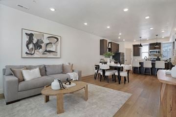 Riverdale townhouse for rent - A modern living room with a grey couch and a coffee table.