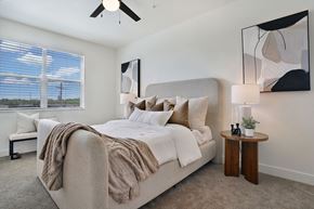 Riverdale townhouse for rent - A bedroom with a large bed and a ceiling fan.