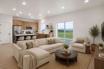 Tooele townhouse for rent - A modern living room with a large sectional sofa and a coffee table.