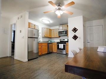 Clearfield apartment for rent - A kitchen with wooden cabinets and a stainless steel refrigerator.