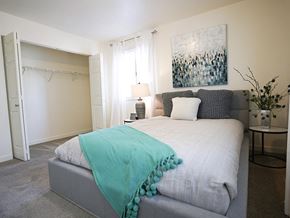 Clearfield apartment for rent - A bedroom with a bed covered in a blue blanket.