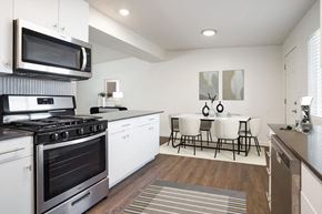 Roy apartment for rent - an open kitchen and dining room with a table and chairs