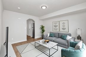 Ogden townhouse for rent - A living room with a grey couch, a coffee table, and a television.