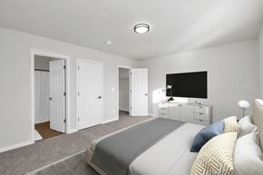 Ogden townhouse for rent - A bedroom with a bed, dresser, and wardrobe.