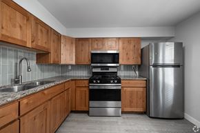 Ogden apartment for rent - A kitchen with wooden cabinets and stainless steel appliances.