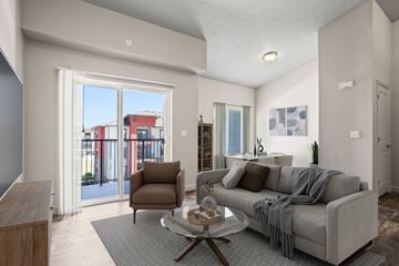 Salt Lake City apartment for rent - A living room with a grey couch and a brown chair.