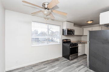 Salt Lake City townhouse for rent - A kitchen with a black refrigerator, stove, and oven.