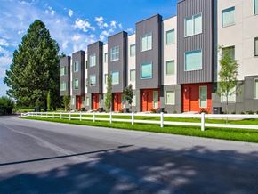 Layton townhouse for rent - a row of houses with red doors and white fences  at Aero Luxury Townhomes in Layton, Utah