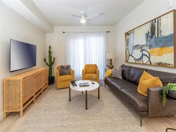 Syracuse apartment for rent - a living room with a leather couch and a coffee table