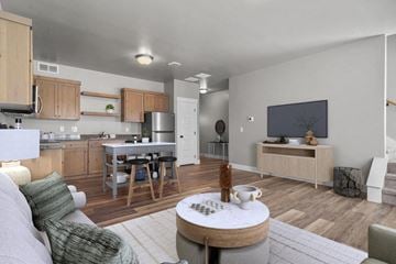 Idaho Falls townhouse for rent - A modern living room with a grey couch and a wooden coffee table.