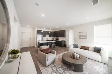 North Ogden apartment for rent - A modern living room with a grey coffee table and a white sofa.