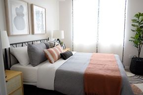 St George apartment for rent - a bedroom with a bed and two paintings on the wall