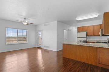 Springville apartment for rent - A kitchen with wooden cabinets and a marble countertop.