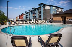 Salt Lake City apartment for rent - Two chairs are placed on the side of a swimming pool.
