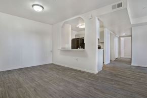 West Valley City apartment for rent - A spacious room with wood flooring and white walls.
