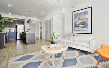 West Jordan apartment for rent - A living room with a white couch and a framed picture on the wall.