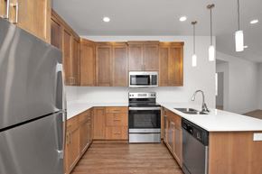 Bountiful apartment for rent - a kitchen with wooden cabinets and stainless steel appliances