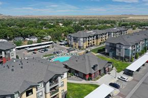 Magna apartment for rent - an aerial view of a large apartment complex with a pool and parking lot