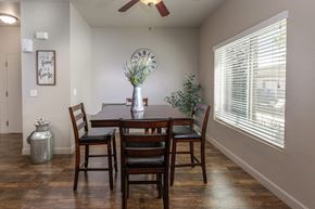 Magna apartment for rent - a dining room with a large clock on the wall