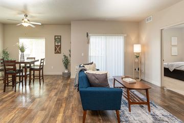 Magna apartment for rent - a living room and dining room with a couch and a table