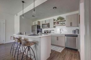 West Haven apartment for rent - A kitchen with a white counter and bar stools.