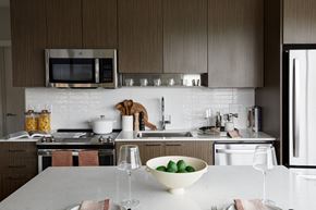 Boston apartment for rent - a kitchen with a white counter top and a bowl of fruit on it
