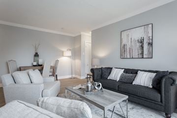 Hamilton apartment for rent - A modern living room with a grey couch and a coffee table.