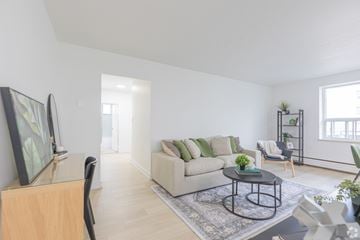 Hamilton apartment for rent - A living room with a couch, a chair, a coffee table, and a painting on the wall.