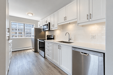 Hamilton apartment for rent - A kitchen with white cabinets and a stainless steel dishwasher.