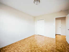 Brampton apartment for rent - A room with a wooden floor and white walls.