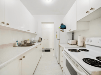 Brampton apartment for rent - A white kitchen with a stove and sink.