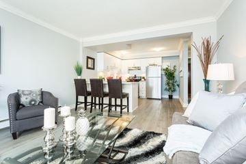 Hamilton apartment for rent - A modern living room with a glass coffee table and a grey sofa.
