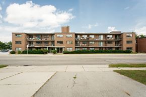 Hamilton apartment for rent - A large brick building with a balcony on the second floor.