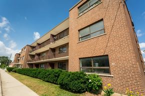 Hamilton apartment for rent - A red brick building with a balcony on the second floor.