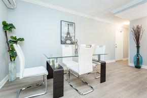 Hamilton apartment for rent - A dining room with a glass table and white chairs.