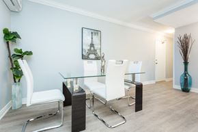 Hamilton apartment for rent - A dining room with a glass table and white chairs.
