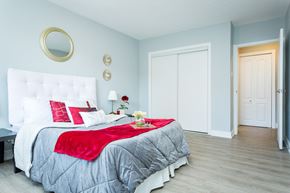 Hamilton apartment for rent - A bedroom with a white bed and a red blanket.