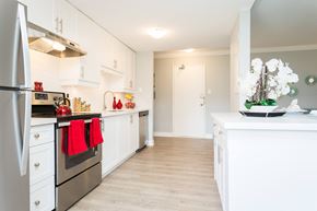 Hamilton apartment for rent - A kitchen with white cabinets and a stainless steel refrigerator.